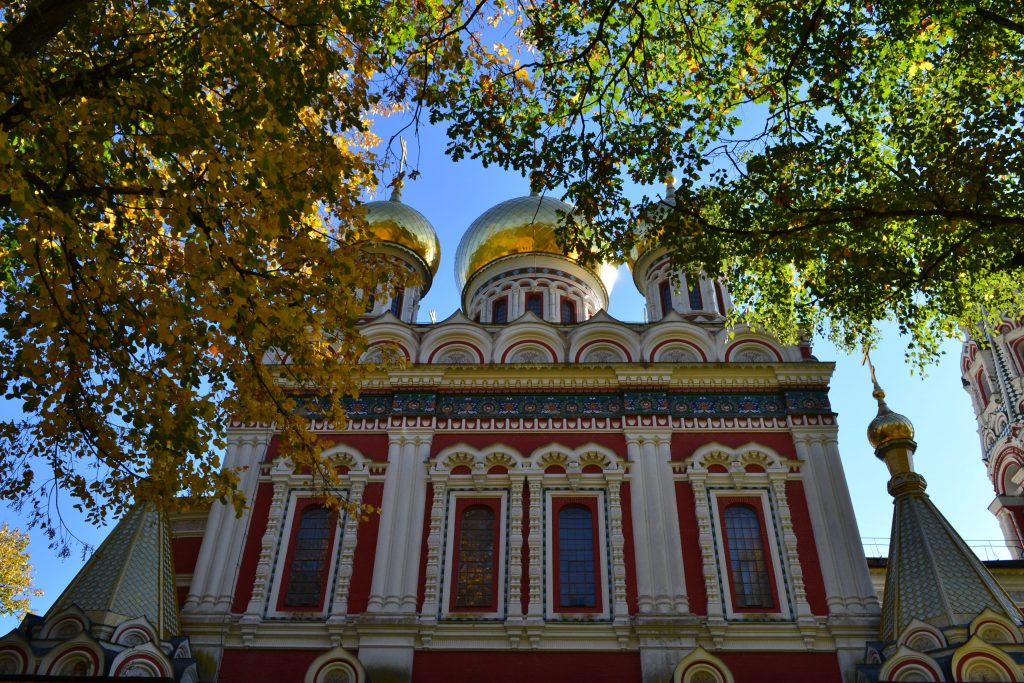 View of the church's façade and onion domes from the northern part of the garden